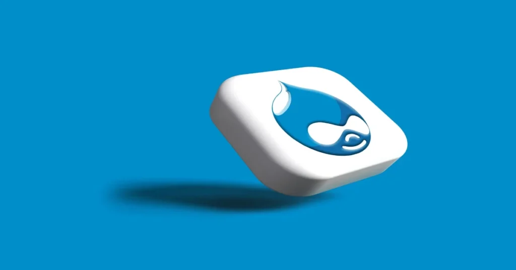 3D rendering of a white, rectangular button with rounded edges, featuring a blue water droplet logo reminiscent of the Drupal vs WordPress debate. The button casts a shadow on a bright blue background.